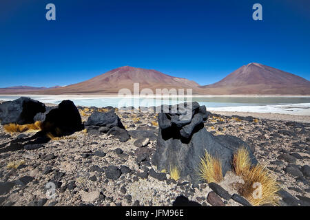 Black volcanic rocks near the Laguna Verde, In the background volcanoes Juriques and Llicancabur, South Lipez, Bolivia, South America Stock Photo