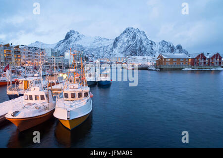 Fishing boats lined up in The port of Henningsvær Fishing Village, Lofoten Islands, Norway Stock Photo