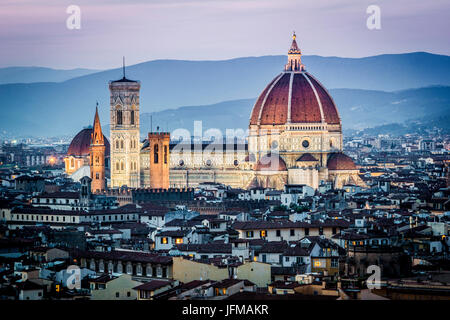 Florence, Tuscany, Italy, cityscape and Cathedral and Brunelleschi Dome, Giotto Tower, Sunset, lights on, Stock Photo