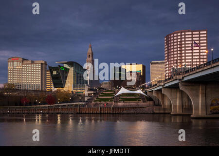 USA, Connecticut, Hartford, city skyline with Connecticut Science Center and Travelers Building, from the Connecticut River, dawn, autumn Stock Photo