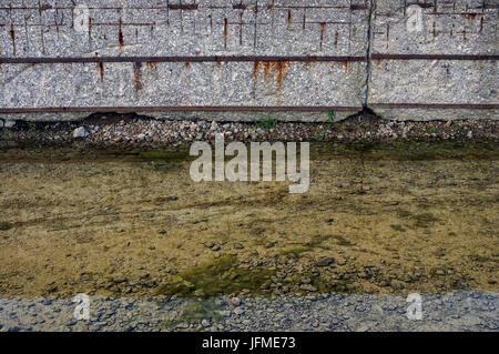 Symbol / Concepts, Puddle near the old concrete wall Stock Photo