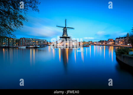 Dusk lights on the Windmill De Adriaan reflected in river Spaarne Haarlem North Holland The Netherlands Europe Stock Photo