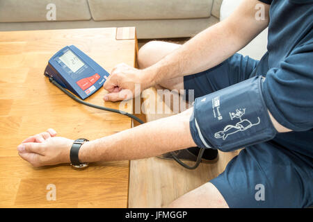 Blood pressure measurement, with an automatic upper arm blood pressure meter, Stock Photo