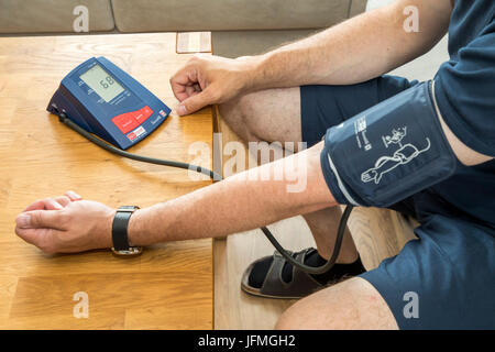 Blood pressure measurement, with an automatic upper arm blood pressure meter, Stock Photo