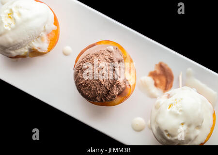 Dessert ice cream on peach, black background Stock Photo