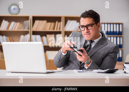 Businessman playing computer games at work office Stock Photo