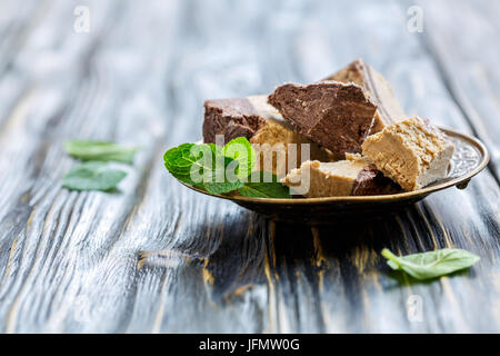 Plate of halva from sesame seeds with chocolate. Stock Photo