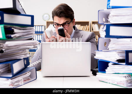 Busy businessman under stress due to excessive work Stock Photo