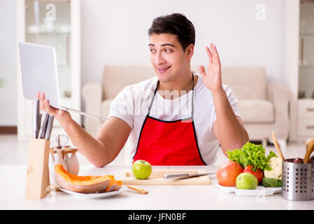 The funny man cook working in the kitchen Stock Photo