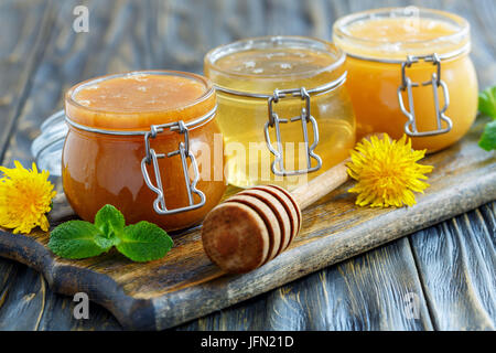 Buckwheat, linden and flower honey in glass jars. Stock Photo