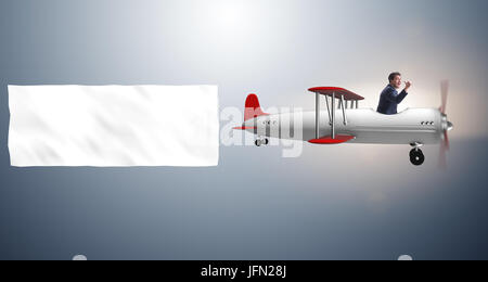The biplane with businessman and blank banner Stock Photo