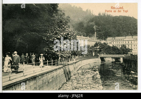 This 1907 postcard captures the scenic view of a bridge over the Teplá River in Karlovy Vary, with the Grandhotel Pupp in the background. The image highlights the beauty and architectural elegance of the region. Stock Photo