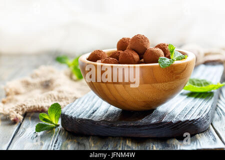 Homemade chocolate truffles in a wooden bowl. Stock Photo