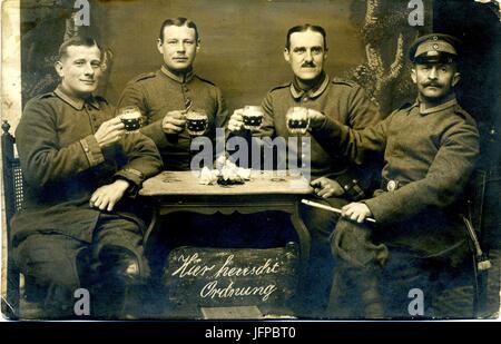 German Officers enjoying a pint of beer 'Here Rules Order' Stock Photo