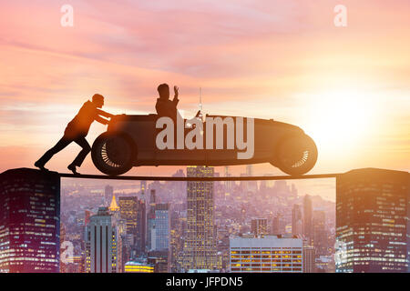 Teamwork concept with businessman pushing car Stock Photo