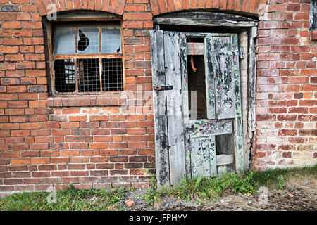 Broken door and window on farm building, Llangollen, Denbighshire, Wales, UK Stock Photo