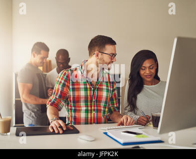 The office team at the computer writing the notes during the meeting. Stock Photo