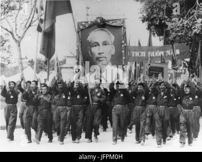 Uniformed students carry portrait of President Ho Chi Minh during parade. Hanoi, Vietnam. 1965 Stock Photo