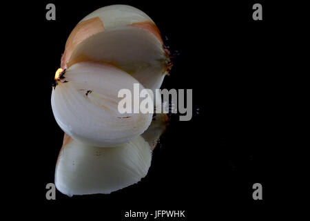 Isolated onions on black background set on fire Stock Photo