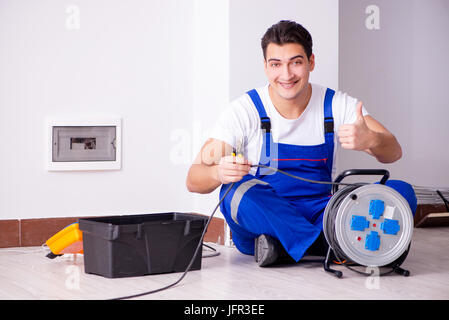Man doing electrical repairs at home Stock Photo