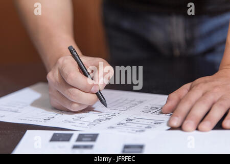 The designer in working process, at a table does sketches by a pencil Stock Photo