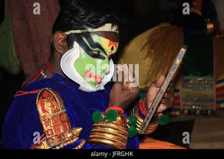 Young Kathakali Artist Getting His Makeup Done in Kerala Stock Photo