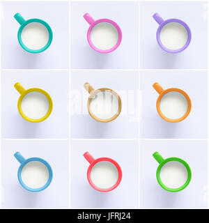 Collage of milk in colorful mugs on paper background Stock Photo
