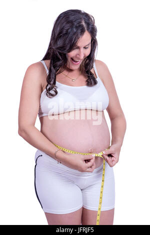 A pregnant woman measuring her belly Stock Photo