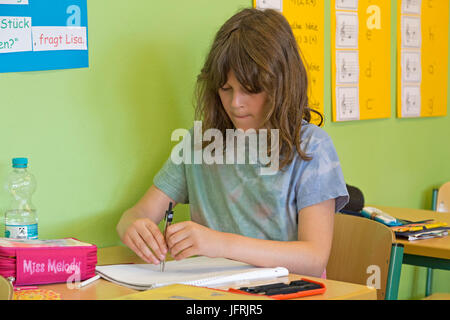 primary school girl working with her compasses Stock Photo - Alamy