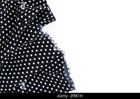 Piece of black fabric with a pattern of white peas, isolated on a white background. Stock Photo