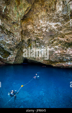 Divers preparing for their  dive in the grotto collapsed cave in Saipan, Northern Marianas, Central Pacific Stock Photo