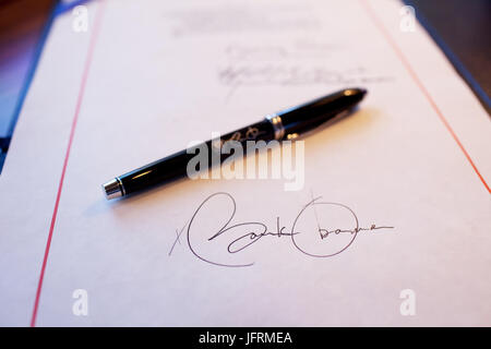 Close-up detail of President Obama's signature on a bill, and a pen used for the signing, aboard Air Force One on a flight from Buckley Air Force Base, Denver Colorado to Phoenix, Arizona 2/17/09.  Official White House Photo by Pete Souza Stock Photo