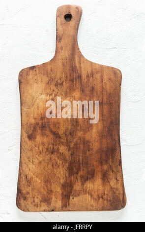 Rustic wooden cutting board on white stone background close up - rustic empty copy space for text, design element Stock Photo