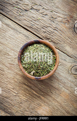 Mixed Italian Herbs Seasoning on wooden background, copy space. Dried Herbs Seasoning, healthy ingredient for cooking. Stock Photo