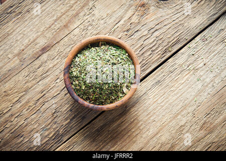 Mixed Italian Herbs Seasoning on wooden background, copy space. Dried Herbs Seasoning, healthy ingredient for cooking. Stock Photo