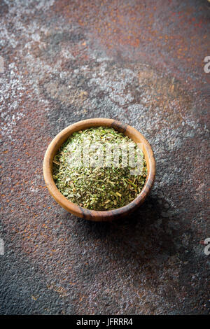 Mixed Italian Herbs Seasoning on rustic metal background, copy space. Dried Herbs Seasoning, healthy ingredient for cooking. Stock Photo