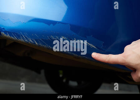 Car paint scratch damage close-up. Insurance damage check Stock Photo