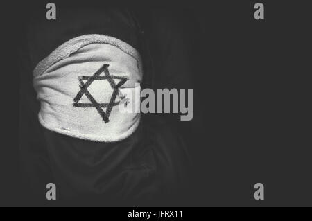 shoulder patch Jewish star of David in concentration camps in Germany. The concept of the genocide of the Jews. The day of memory of victims of the Ho Stock Photo