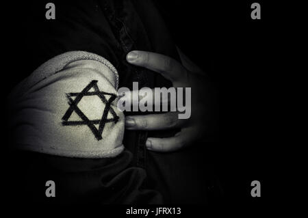 hand with the badge of the star of David. The concept of the Holocaust stylized 1940s. The memory of the victims of the Holocaust. black and white ret Stock Photo