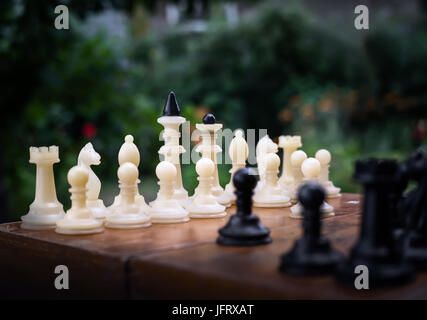 chess pieces on a table in the park Stock Photo