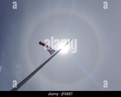 Marawi City, Philippines. 02nd July, 2017. Sun halo or rainbow around the sun appeared in the war-torn Marawi City. Halos were caused by both refraction, or splitting of light, and reflection, or glints of light from ice crystals in the atmosphere. Credit: Sherbien Dacalanio/Pacific Press/Alamy Live News Stock Photo