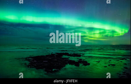 Aurora borealis over the sea, Gardur, Iceland Stock Photo