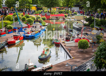 Billund, Denmark - July 27, 2017:  Ships docks at the harbour built of lego bricks. People walking through the Lego city in Legoland, Denmark Stock Photo