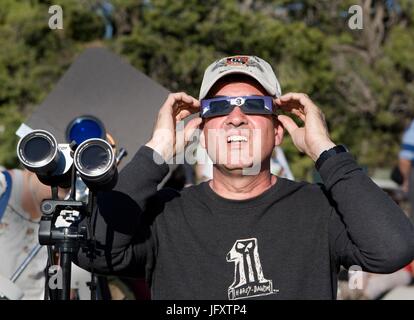 Park visitors watch the annular solar eclipse through protective solar glasses at the Grand Canyon National Park Visitor Center May 20, 2012 in Grand Canyon Village, Arizona.    (photo by W. Tyson Joye via Planetpix) Stock Photo