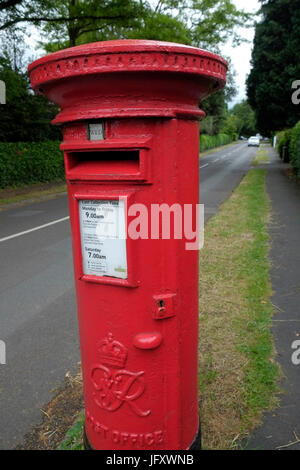 A red Royal Mail post box in a leafy suburb of Bristol Stock Photo