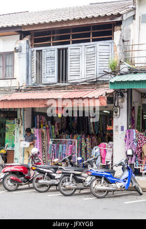 Motorbikes parked outside an old Sino Portuguese style architecture shop in Thalang Road, Phuket, Thailand Stock Photo