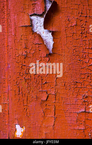 Cracked wall with old layers of paint in abandoned house. Background Stock Photo