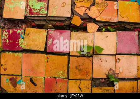 Cracked retro old tiles floor background texture. Vintage color dirty broken tile Stock Photo