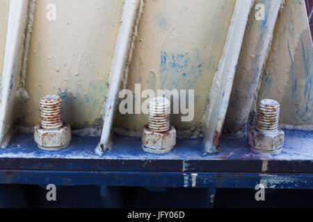 Big rusty metal nuts locked with rust and corrosion bolts Stock Photo