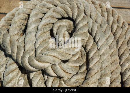 A photograph of nautical rope in a pile on the deck of a boat in Malta Stock Photo